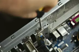 A technician repairing a desktop computer. This image has selective focus